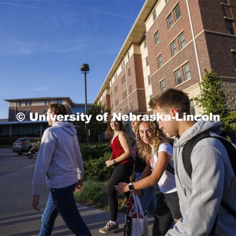 Students leaving University Suites Residence Hall to get to their classes. Housing Photo Shoot in University Suites Residence Hall. September 27, 2022. Photo by Craig Chandler / University Communication.