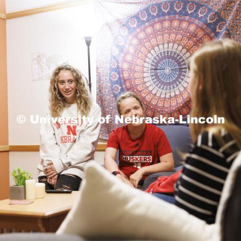 Students socializing in a University Suites Residence Hall room. Housing Photo Shoot in University Suites Residence Hall. September 27, 2022. Photo by Craig Chandler / University Communication.