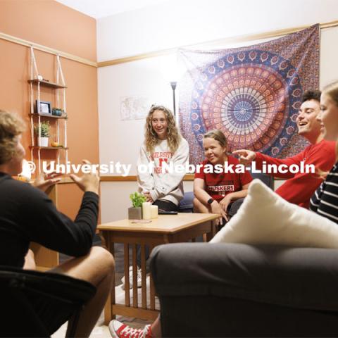 Students socializing in a University Suites Residence Hall room. Housing Photo Shoot in University Suites Residence Hall. September 27, 2022. Photo by Craig Chandler / University Communication.