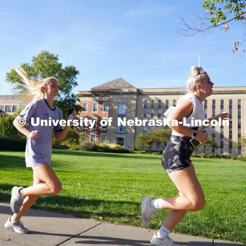 Members of Tri-Delta Sorority sprint past Love Library towards the finish line at the Homecoming Traditions Race. The Traditions Race will consist of clues leading to 10-15 traditions around campus, and the first three teams to find every tradition will be declared winners! September 27, 2022. Photo by Dillon Galloway for University Communication.