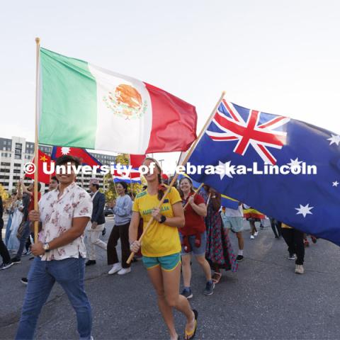 International students carry their flags in the Homecoming Parade and Cornstalk. September 30, 2022. Photo by Craig Chandler / University Communication.