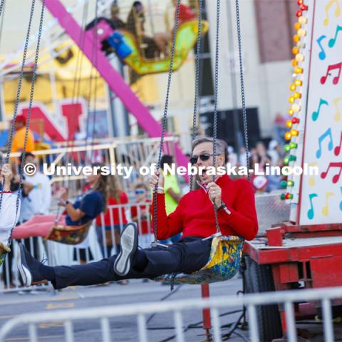 UNL Chancellor Ronnie Green and Husker Jane, his wife, take a spin on the Musical Chairs amusement ride at Cornstalk. Homecoming Parade and Cornstalk. September 30, 2022. Photo by Craig Chandler / University Communication.