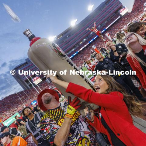 Soon-to-be-crowned homecoming royalty Emily Hatterman fires a hot dog into the crowd from Der Viener Schlinger as each of the homecoming candidates took a turn on the schlinger. Homecoming game. Nebraska football vs. Indiana.  October 1, 2022. Photo by Craig Chandler / University Communication. 