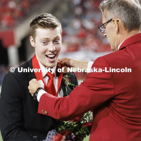 Newly crowned homecoming royalty Jacob Drake has a medallion placed over his head by Chancellor Ronnie Green. Nebraska vs. Indiana football Homecoming game. October 1, 2022. Photo by Craig Chandler / University Communication.