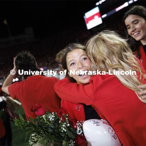 Newly crowned homecoming royalty Emily Hatterman gets a hug as she leaves the field. Nebraska vs. Indiana football Homecoming game. October 1, 2022. Photo by Craig Chandler / University Communication.