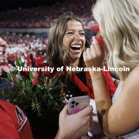 Newly crowned homecoming royalty Emily Hatterman is surrounded by friends Malori Grabast, left, and Willa Scoville as she leaves the field. Nebraska vs. Indiana football Homecoming game. October 1, 2022. Photo by Craig Chandler / University Communication.