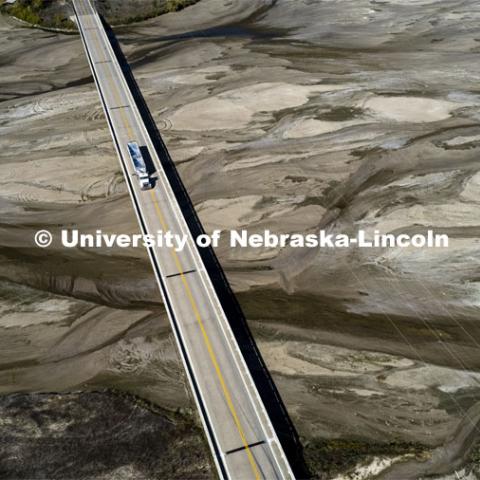 A grain semi crosses the dry Platte River at Chapman, Nebraska. The area around Chapman is in severe/extreme drought according to UNL’s drought monitor. October 13, 2022. Photo by Craig Chandler / University Communication.