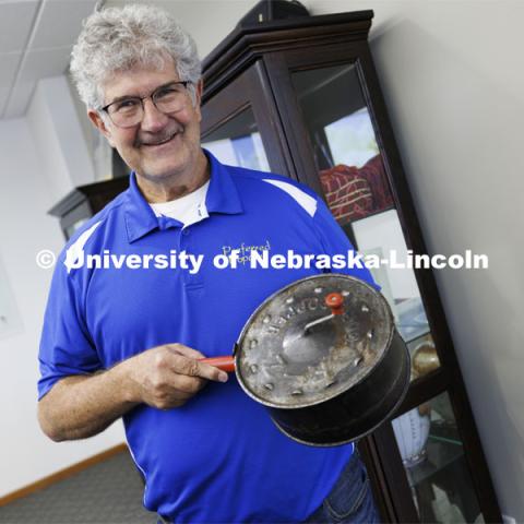 Norm Krug proudly shows his grandfather’s popcorn popper. The popper resides in a case in the company’s conference room. Preferred Popcorn grows popcorn near Chapman, Nebraska and throughout the area. It is headed by Norm Krug. October 13, 2022. Photo by Craig Chandler / University Communication.