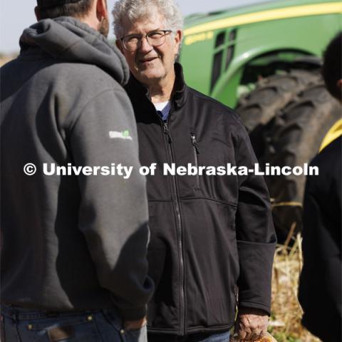 Sample in hand, Norm Krug talks with Andrew McHargue before taking the sample back to the office for testing. Preferred Popcorn grows popcorn near Chapman, Nebraska and throughout the area. It is headed by Norm Krug. October 13, 2022. Photo by Craig Chandler / University Communication.