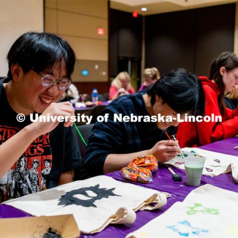 Students, Kevin Nguyen (left) and Thomas Dinh (right), paint tote bags at the Husker Haunt in the Nebraska East Union. October 20, 2022. Photo by Jonah Tran/ University Communication.