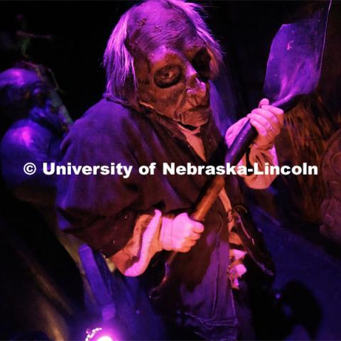 Jackson Wells performs as the Gravedigger as he awaits the next group to scare on a recent Friday evening. ShakesFear production in the Temple Building. October 21, 2022. Photo by Craig Chandler / University Communication.