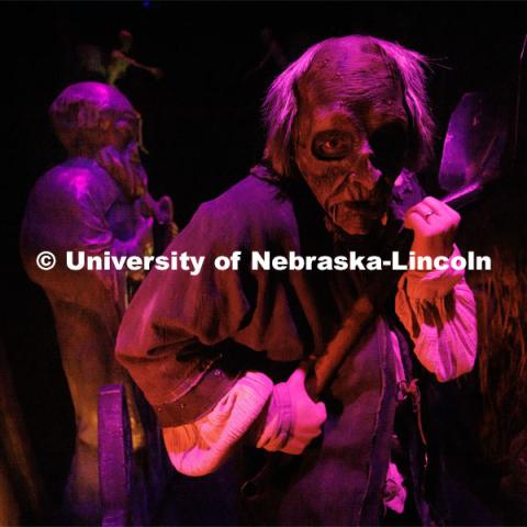 Jackson Wells performs as the Gravedigger as he awaits the next group to scare on a recent Friday evening. ShakesFear production in the Temple Building. October 21, 2022. Photo by Craig Chandler / University Communication.