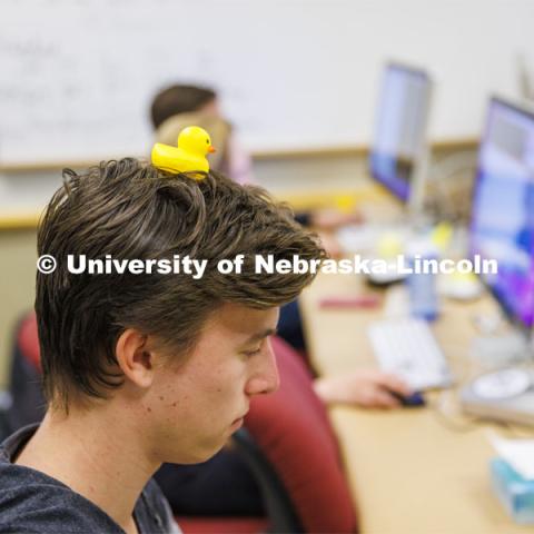 Student with a rubber duckie on his head. Students working in a classroom. Raikes School photo shoot. October 27, 2022. Photo by Craig Chandler / University Communication. 