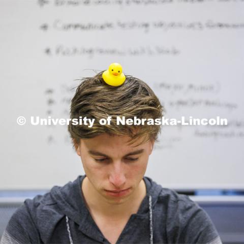 Student with a rubber duckie on his head. Students working in a classroom. Raikes School photo shoot. October 27, 2022. Photo by Craig Chandler / University Communication. 