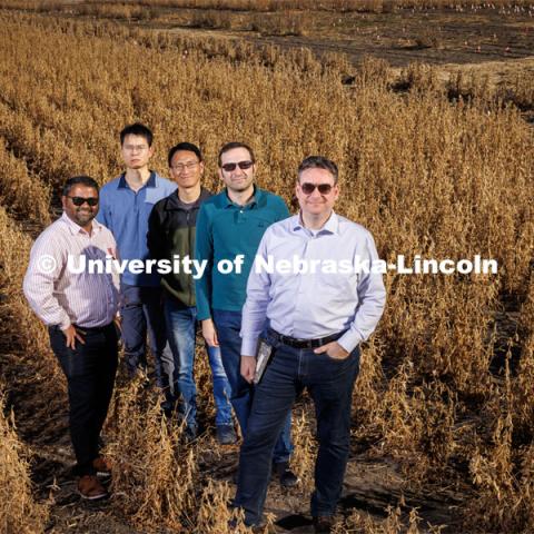 Members of the Field-Nets research team pose in a soybean field on east campus field with their Millimeter-wave (mmWave) radios with phased-array antennas. The researchers (from left) are Santosh Pitla, Qiang Liu, Yufeng Ge, Christos Argyropoulos and Mehmet Can Vuran. October 28, 2022. Photo by Craig Chandler / University Communication.
