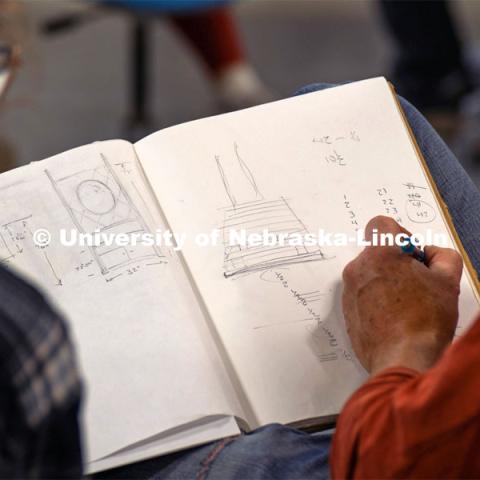 Iowa State professor Chris Martin goes over a sketch idea with a student. Architecture design professor Aziza Cyamani is doing a weekend long furniture design-build sprint with Professor Chris Martin from Iowa State University. The students will come Friday, Saturday and Sunday and make something out of wood and another version using a new technology like 3D printing. October 30, 2022. Photo by Kirk Rangel for University Communication.