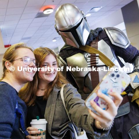 Sam Pharris, a freshman from Aberdeen, South Dakota, and Violet Curran, a freshman from Philadelphia, pose with the Mandalorian in the Nebraska Union. Halloween on City Campus. October 31, 2022. Photo by Craig Chandler / University Communication.