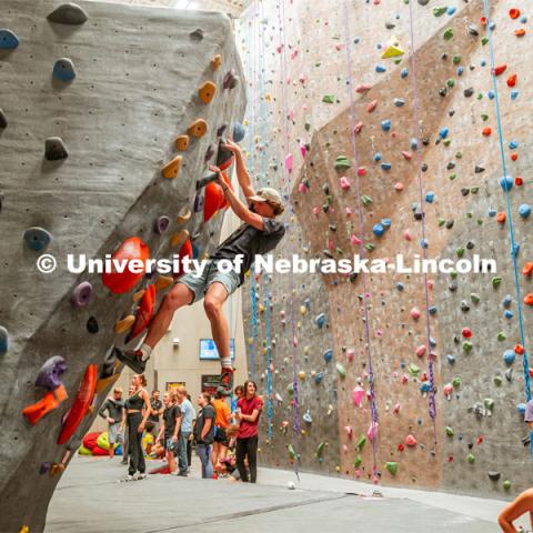 Cole Brady, sophomore, climbing a boulder route during the League of Extraordinary Boulderers. League of Extraordinary Boulderers scale the climbing wall at Campus Recreation’s Outdoor Adventure Center. November 3, 2022. Photo by Jonah Tran / University Communication.