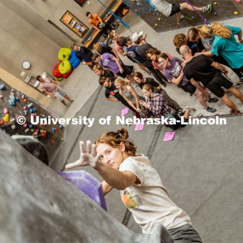 Allison Linton, senior, climbing a boulder route during the League of Extraordinary Boulderers. League of Extraordinary Boulderers scale the climbing wall at Campus Recreation’s Outdoor Adventure Center. November 3, 2022. Photo by Jonah Tran / University Communication.