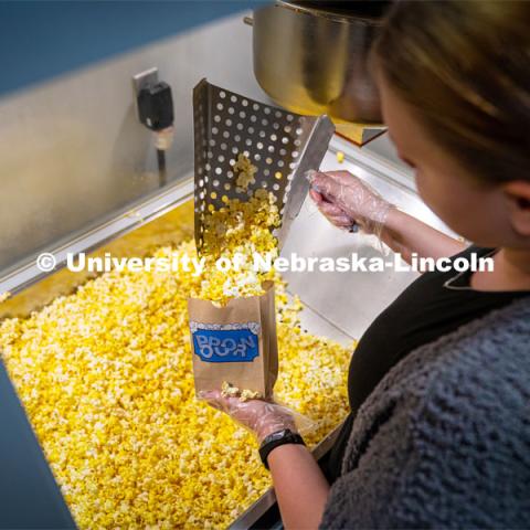 Freshman Emma Georgia helps prepare popcorn for moviegoers at the Ross Theater November 9, 2022. Photo by Dillon Galloway for University Communication