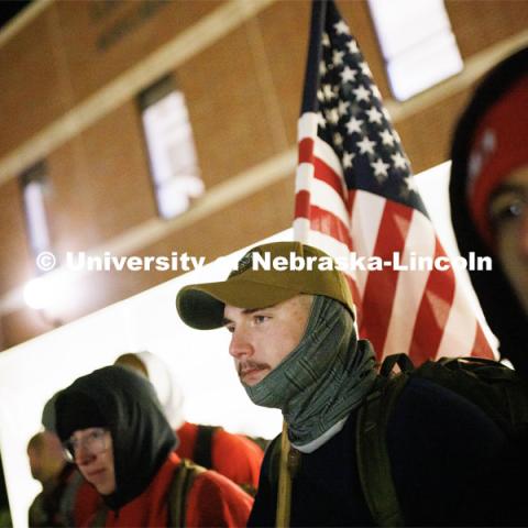 Cohan Bonow, senior in management and a Naval ROTC midshipman, stands with fellow marchers before the start of the marching. Nebraska students and veterans march from Memorial Stadium Wednesday morning. "The Things They Carry" ruck march involving military and veteran students from Iowa and Nebraska. To raise awareness about veteran suicide, through the week, the students walk in 20-mile shifts carrying 20-pound backpacks to commemorate the estimated 20 veterans who die by suicide each day. November 15, 2022. Photo by Craig Chandler / University Communication.