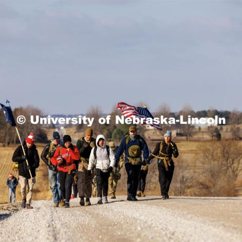 Ruck Marchers walk along Holdrege Street in rural eastern Lancaster County. Nebraska students and veterans march from Memorial Stadium Wednesday morning. "The Things They Carry" ruck march involving military and veteran students from Iowa and Nebraska. To raise awareness about veteran suicide, through the week, the students walk in 20-mile shifts carrying 20-pound backpacks to commemorate the estimated 20 veterans who die by suicide each day. November 15, 2022. Photo by Craig Chandler / University Communication.