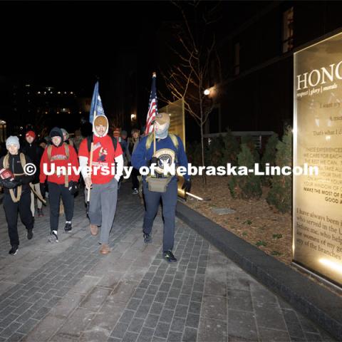 Ruck Marchers begin the march going through the Veterans Tribute. From left is Midshipman Abby Thibodeau, Midshipman Gabrielle Martinez, UNL alumni and veteran Connor Williams and Midshipman Cohan Bonow. Nebraska students and veterans march from Memorial Stadium Wednesday morning. "The Things They Carry" ruck march involving military and veteran students from Iowa and Nebraska. To raise awareness about veteran suicide, through the week, the students walk in 20-mile shifts carrying 20-pound backpacks to commemorate the estimated 20 veterans who die by suicide each day. November 15, 2022. Photo by Craig Chandler / University Communication.