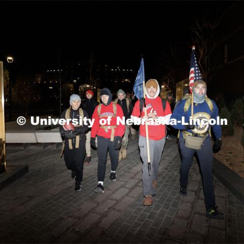 Ruck Marchers begin the march going through the Veterans Tribute. From left is Midshipman Abby Thibodeau, Midshipman Gabrielle Martinez, UNL alumni and veteran Connor Williams and Midshipman Cohan Bonow. Nebraska students and veterans march from Memorial Stadium Wednesday morning. "The Things They Carry" ruck march involving military and veteran students from Iowa and Nebraska. To raise awareness about veteran suicide, through the week, the students walk in 20-mile shifts carrying 20-pound backpacks to commemorate the estimated 20 veterans who die by suicide each day. November 15, 2022. Photo by Craig Chandler / University Communication.