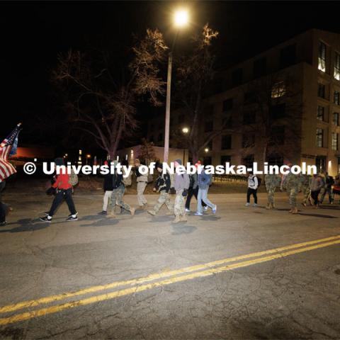 Ruck Marchers begin the march going east through the Veterans Tribute and along Vine street. Nebraska students and veterans march from Memorial Stadium Wednesday morning. "The Things They Carry" ruck march involving military and veteran students from Iowa and Nebraska. To raise awareness about veteran suicide, through the week, the students walk in 20-mile shifts carrying 20-pound backpacks to commemorate the estimated 20 veterans who die by suicide each day. November 15, 2022. Photo by Craig Chandler / University Communication.