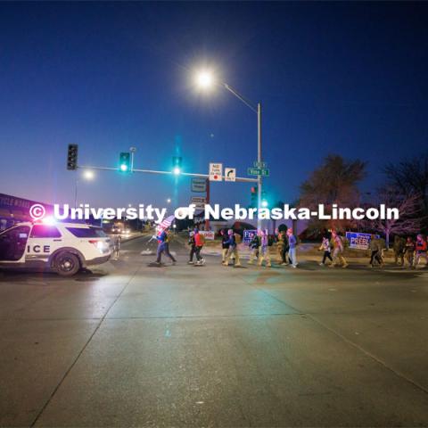 Ruck Marchers begin the march going east through the Veterans Tribute and along Vine street. Nebraska students and veterans march from Memorial Stadium Wednesday morning. "The Things They Carry" ruck march involving military and veteran students from Iowa and Nebraska. To raise awareness about veteran suicide, through the week, the students walk in 20-mile shifts carrying 20-pound backpacks to commemorate the estimated 20 veterans who die by suicide each day. November 15, 2022. Photo by Craig Chandler / University Communication.