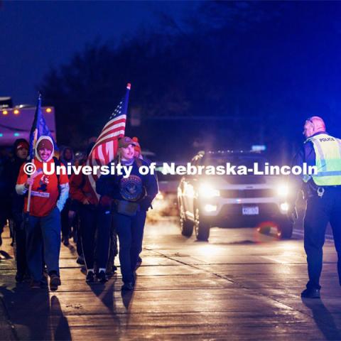 Ruck Marchers begin the march going east through the Veterans Tribute and along Vine street. From left is UNL alumni and veteran Connor Williams and Midshipman Cohan Bonow. Nebraska students and veterans march from Memorial Stadium Wednesday morning. "The Things They Carry" ruck march involving military and veteran students from Iowa and Nebraska. To raise awareness about veteran suicide, through the week, the students walk in 20-mile shifts carrying 20-pound backpacks to commemorate the estimated 20 veterans who die by suicide each day. November 15, 2022. Photo by Craig Chandler / University Communication.