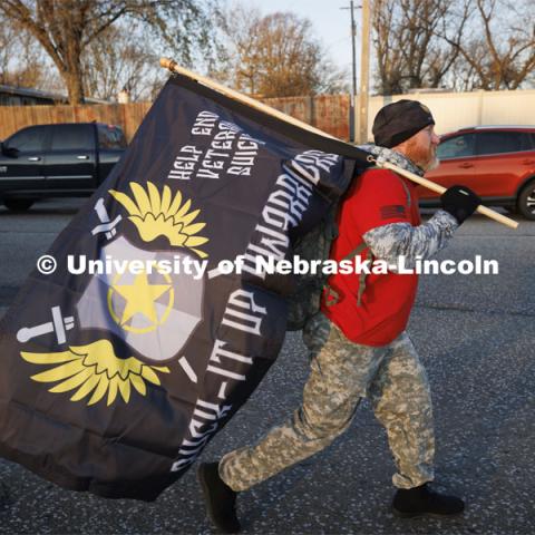 Scott Fredenburg, a retired Army veteran and leader of Ruck-It-Up Warriors, walks in the ruck march. Nebraska students and veterans march from Memorial Stadium Wednesday morning. "The Things They Carry" ruck march involving military and veteran students from Iowa and Nebraska. To raise awareness about veteran suicide, through the week, the students walk in 20-mile shifts carrying 20-pound backpacks to commemorate the estimated 20 veterans who die by suicide each day. November 15, 2022. Photo by Craig Chandler / University Communication.