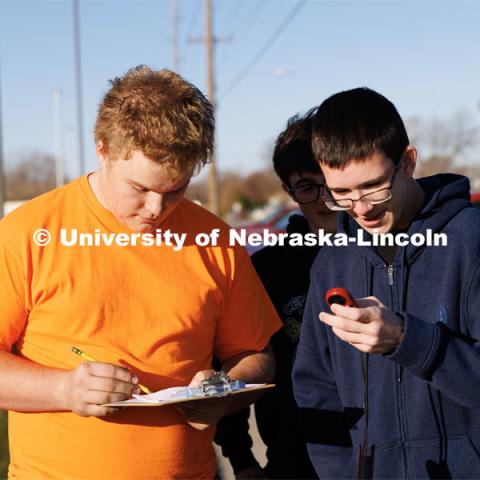 Levi Vaughan, left, and Caleb Rowe measure outdoor weather as part fo the records gathered for their anthropometric measurements. Chelle Gillan and her Central City class are studying anthropometric differences around the globe. Gillan spent time this summer in Kenya gathering physical data there so students in her Advanced Biology classes could compare and do research. November 18, 2022. Photo by Craig Chandler / University Communication.