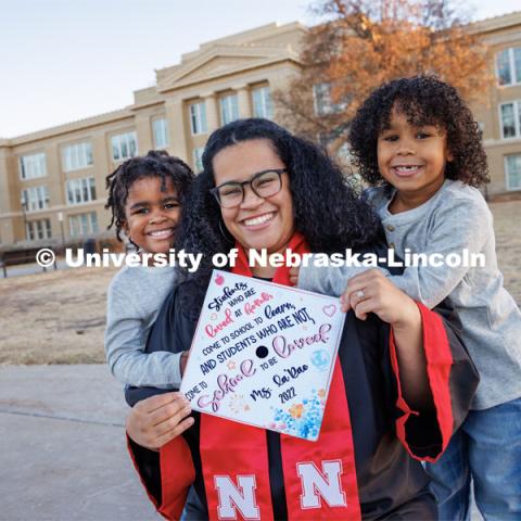 La’Rae Pickens-Bonebright with her sons Amarien, 6, and JJ, 4. In the background stands Lincoln High School, which Pickens-Bonebright attended while carrying each of the boys. Pickens-Bonebright will graduate with her bachelor’s in elementary education and early childhood education. December 1, 2022. Photo by Craig Chandler / University Communication.