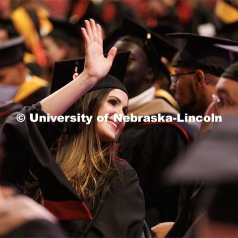 Tara Asgarpoor waves to family and friends before the Graduate Commencement in Pinnacle Bank Arena. December 16, 2022. Photo by Craig Chandler / University Communication.