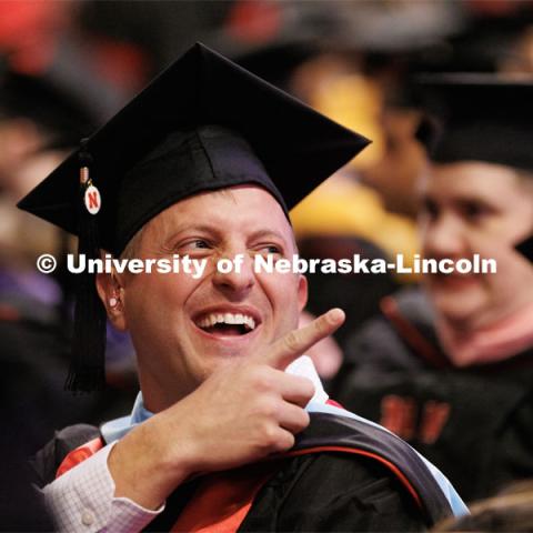 Zachariah High gestures to his family and friends. Graduate Commencement in Pinnacle Bank Arena. December 16, 2022. Photo by Craig Chandler / University Communication.