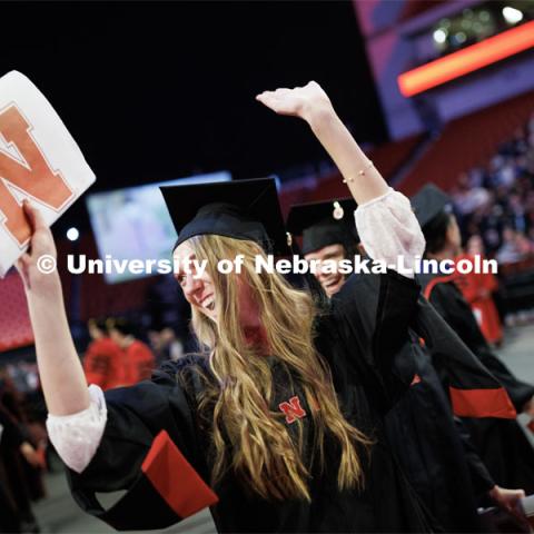 Erika Dreifurst celebrates here masters degree during the recessional. Graduate Commencement in Pinnacle Bank Arena. December 16, 2022. Photo by Craig Chandler / University Communication.