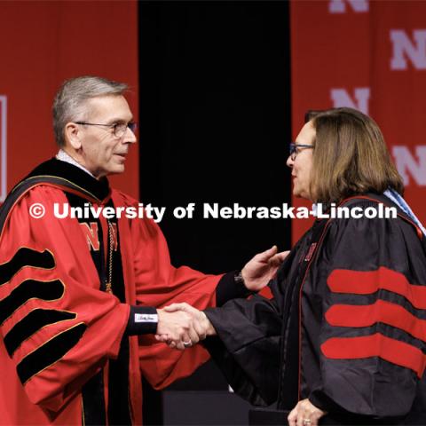 Chancellor Ronnie Green greets Deb Fischer, United States Senator for Nebraska, before she gives the commencement address. Winter Undergraduate Commencement in Pinnacle Bank Arena. December 17, 2022. Photo by Craig Chandler / University Communication.