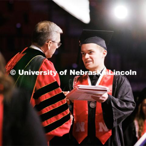 Chancellor Scholar and Elementary Education graduate Brett Foster receives his diplomas from Chancellor Ronnie Green. Winter Undergraduate Commencement in Pinnacle Bank Arena. December 17, 2022. Photo by Craig Chandler / University Communication.