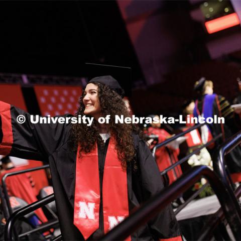 Ariel Zavala, a graduate in Animal Science, takes a selfie as she walks off stage. Winter Undergraduate Commencement in Pinnacle Bank Arena. December 17, 2022. Photo by Craig Chandler / University Communication.