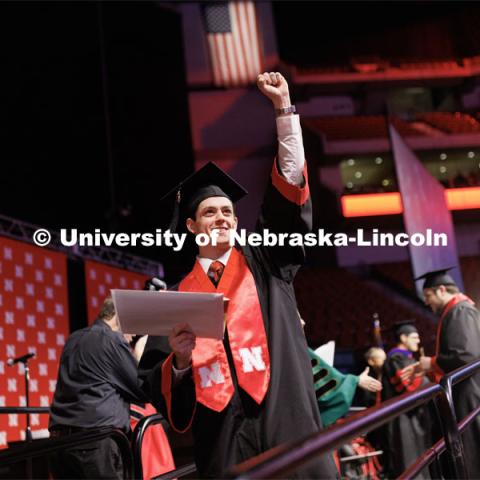 Ryan Yetts, a graduate in Sports Media and Communication, waves to family and friends. Winter Undergraduate Commencement in Pinnacle Bank Arena. December 17, 2022. Photo by Craig Chandler / University Communication.