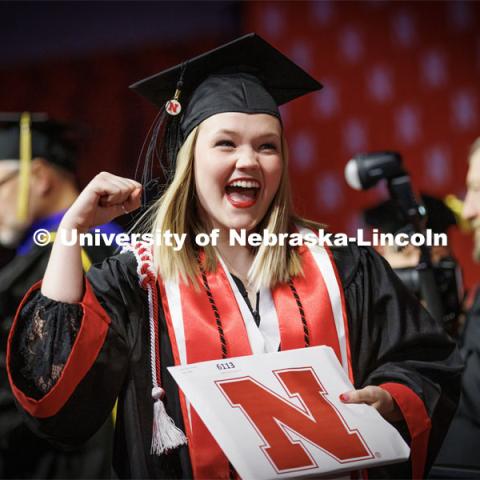 Kaylie Trumble, a Speech-Language Pathologist graduate, shows off her diploma to the Husker Vision cameras Saturday. Winter Undergraduate Commencement in Pinnacle Bank Arena. December 17, 2022. Photo by Craig Chandler / University Communication.