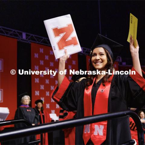 Leslie Castaneda, a graduate in Criminology and Criminal Justice, smiles as she walks across stage. Winter Undergraduate Commencement in Pinnacle Bank Arena. December 17, 2022. Photo by Craig Chandler / University Communication.