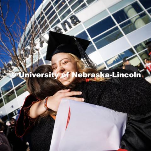 Marissa Heimes, a graduate in Nutritional Science and Dietetics, hugs a friend following commencement. Winter Undergraduate Commencement in Pinnacle Bank Arena. December 17, 2022. Photo by Craig Chandler / University Communication.