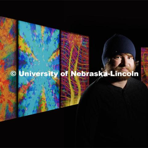 Sage Reiger, a videographer/editor with Nebraska Public Media, has synesthesia and his brain processes music as colors.  He has produced artwork to show what he hears. His musical artwork from left are: Bob Dylan’s Stuck Inside of Mobile with the Memphis Blues Again, Denzel Curry’s Melt Session #1, Porter Robinson’s Musician, Phil Collins’ In the Air Tonight and Injury Reserve’s Superman That. December 19, 2022. Photo by Craig Chandler / University Communication.