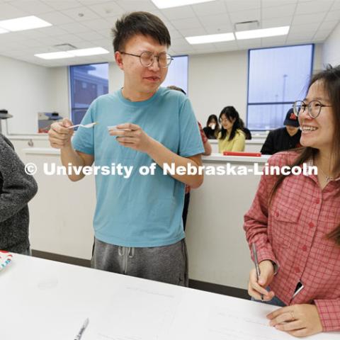 Nanqing Bian reacts to the taste of a soy sauce as he and teammates Zhengchun Han, left, and Yan Sun. Heather Hallen-Adams teaches FDST 492 - Special Topics in Food Science and Technology topic Moldy Meals: Koji and More. January 10, 2023. Photo by Craig Chandler / University Communication.