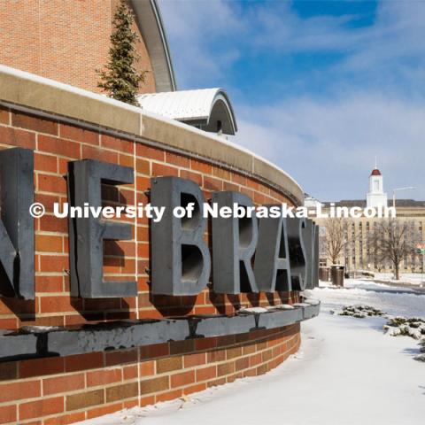 Close up of the sign out front of the Van Brunt Visitor’s Center. Ice and snow cover campus. January 19, 2023. Photo by Craig Chandler / University Communication.