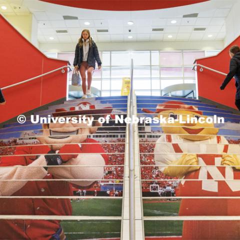 Students walk up the stairs in the Nebraska Union. City Campus. January 25, 2023. Photo by Craig Chandler / University Communication.