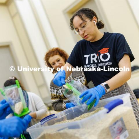 Mona Miller, a sophomore from Omaha, scoops oatmeal into bags as part of MLK Week events. Volunteers assemble hunger kits filled with oatmeal. The goal was more than 2,000 kits. January 25, 2023. Photo by Craig Chandler / University Communication.