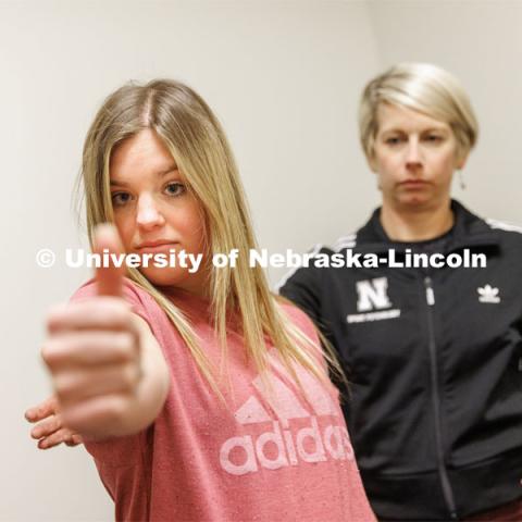 Dr. Kate Higgins, an Athletic Neuropsychologist with Husker Athletics, performs a Visual Motion Sensitivity task during Vestibular Ocular Motor Screening on mock patient Makayla Burchett, a freshman from Harlan, Iowa. Burchett holds her thumb out and rotates left and right while moving her head to follow the thumb. The University Health Center and Nebraska Medicine recently moved its concussion clinic to the Nebraska Performance Lab in the east stadium space. February 1, 2023. Photo by Craig Chandler / University Communication.